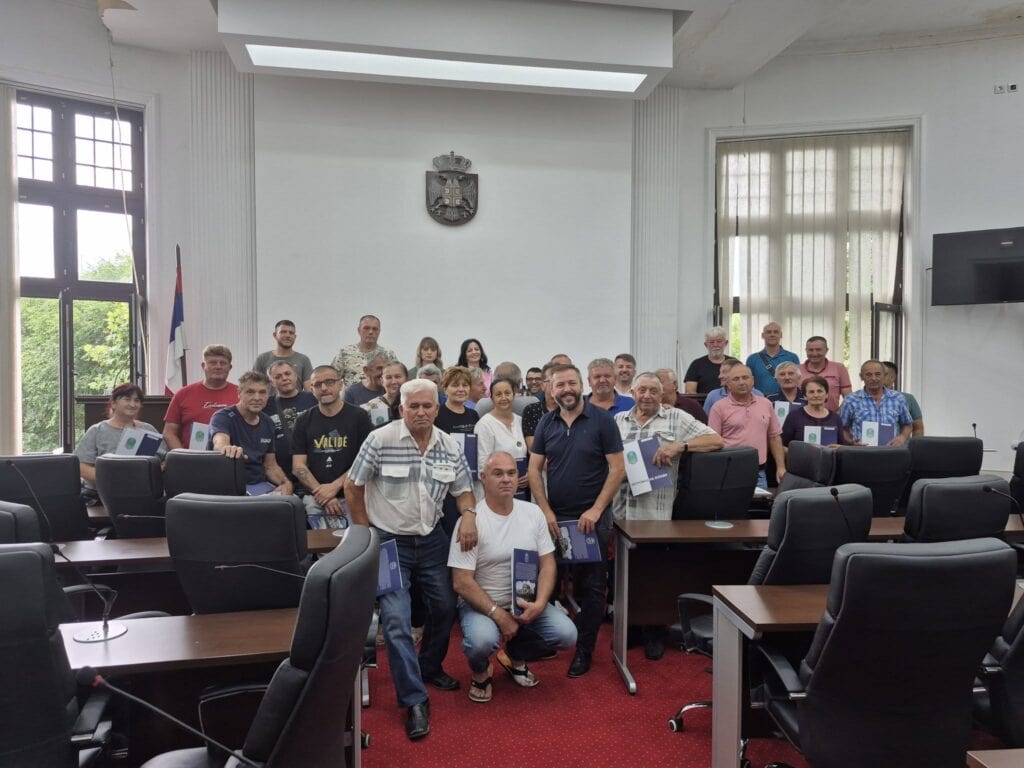 Grupa ljudi na sastanku u opštinskoj sali u Petrovcu na Mlavi.