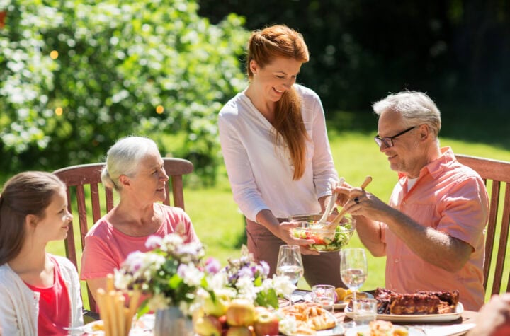 Happy family having dinner or summer garden party